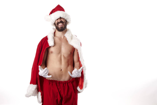 Santa Claus bodybuilder showing off his athletic body on a white background - Foto, Imagen