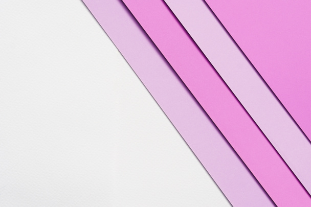 abstract background concept with colorful paper stacking and soft shadow on blank white paper, pink paper, purple  paper stacking on white background, flat lay. - 写真・画像
