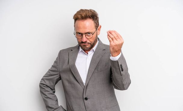 middle age handsome man making capice or money gesture, telling you to pay. businessman concept - 写真・画像