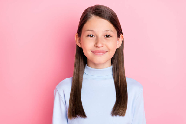 Portrait of attractive cheerful preteen girl wearing casual pullover isolated over pink pastel color background - Foto, Imagen