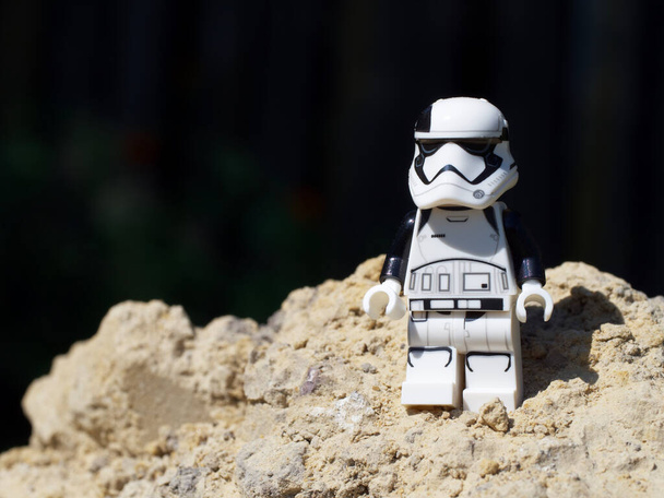 Chernihiv, Ukraine, July 13, 2021. An Imperial stormtrooper on a sandy surface. A plastic minifigure of a Star Wars character. Illustrative editorial. - Photo, Image