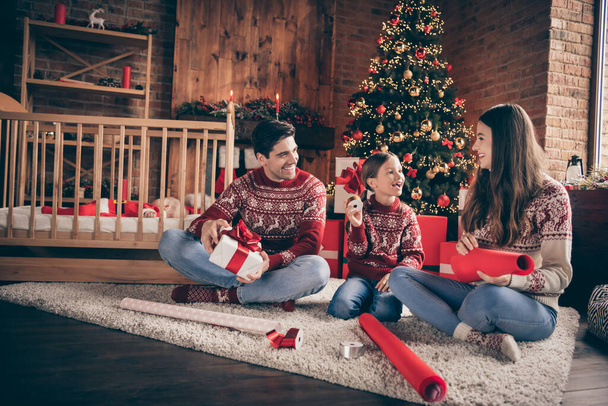 Full size photo of funky young brunette family mom dad daughter new born son sit pack present wear red sweater jeans socks in living room - Фото, зображення