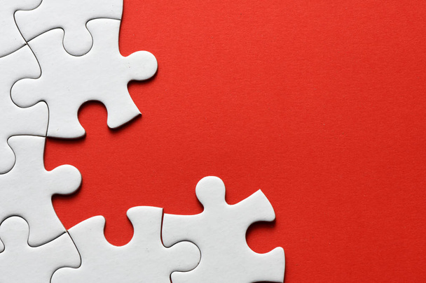 Red jigsaw puzzle pieces on red background. Copy space and business concept - Zdjęcie, obraz