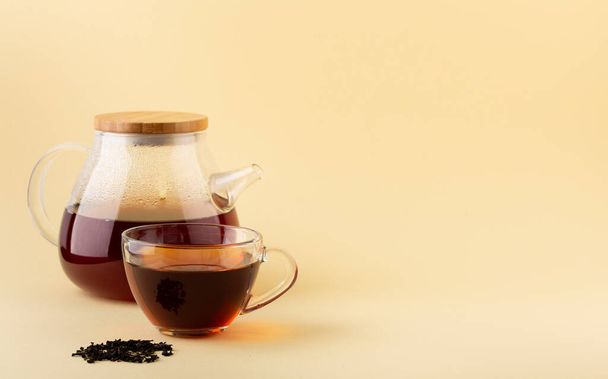 Glass transparent teapot and cup with black tea copy space - Foto, Imagem