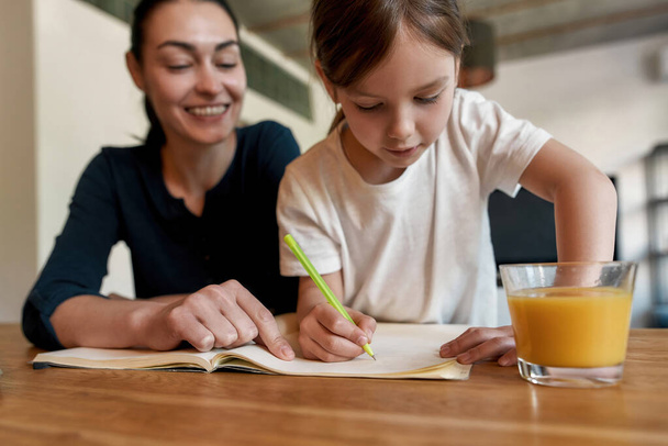 Smart small girl child handwrite in exercise book - Foto, imagen