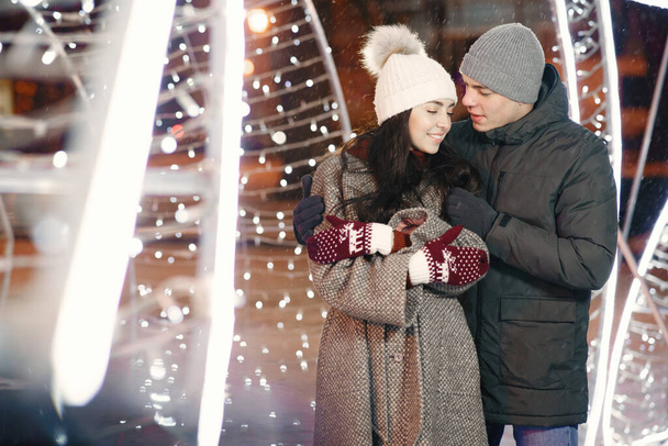 Young couple outdoor in night street at christmas time - Fotoğraf, Görsel