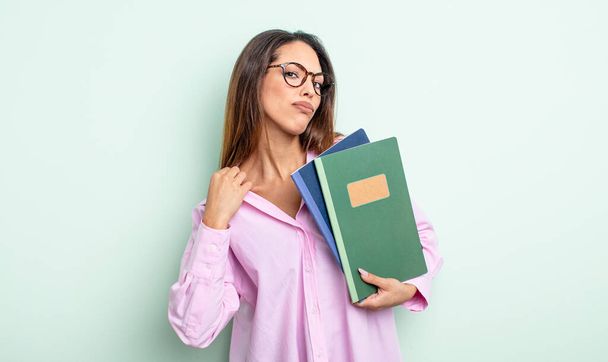 pretty hispanic woman looking arrogant, successful, positive and proud. notebooks concept - Photo, image