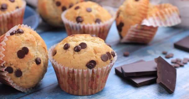 Muffiny s čokoládovými lupínky na dřevěném pozadí. Zdravé ingredience sladkosti koncept. Dolly shot 4k - Záběry, video