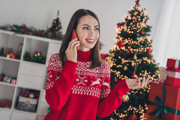 Photo of young lovely girl speak listen smartphone online evergreen tree decoration december indoors - Fotografie, Obrázek