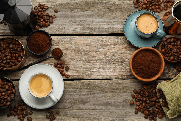 Coffee maker, beans, powder and cup of drink on wooden table, flat lay. Space for text - Foto, Imagem