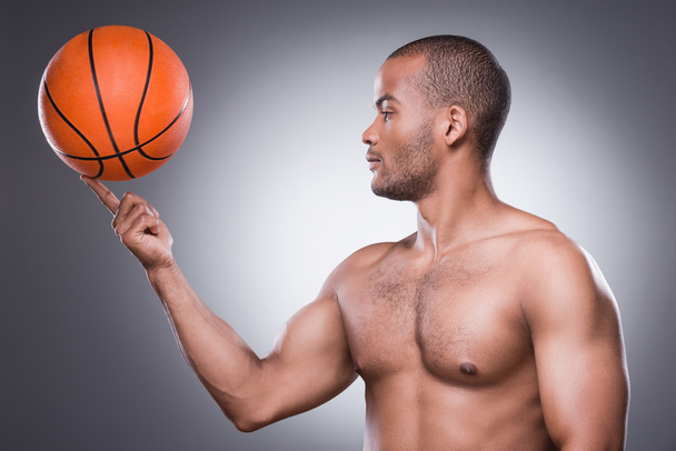 African man carrying basketball ball on finger - Photo, Image