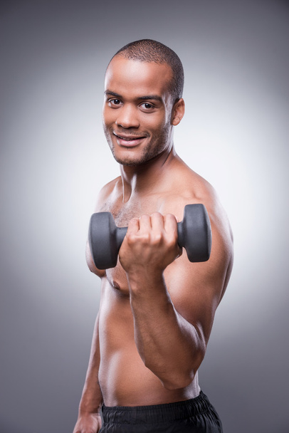 African man exercising with dumbbell - Zdjęcie, obraz