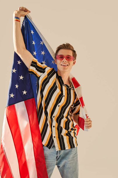 Young USA student celebrating national day with American flag at his hands - Zdjęcie, obraz