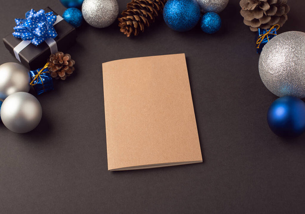 A diary (notebook) among Christmas balls and cones. New year goals concept. - Fotoğraf, Görsel