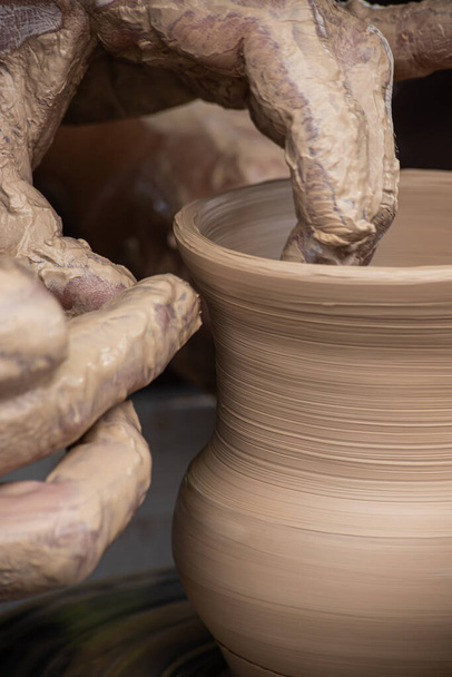 Master class on modeling of clay on a potter's wheel In the pottery workshop. - Photo, Image