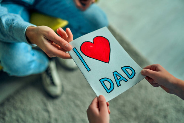 Daughter congratulate father and gives him a postcard on Happy Father's Day! - Photo, Image