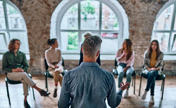 Young members of anonymous alcoholics club share their experience, get support and psychological help, have conversation. Help, support, alcoholics and drug users club, addiction concept. Back view - Fotoğraf, Görsel
