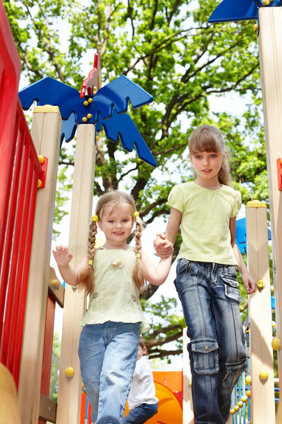 Children on slide outdoor in park. - Foto, afbeelding