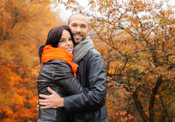 Happy middle-aged couple outdoors on beautiful autumn day - Valokuva, kuva