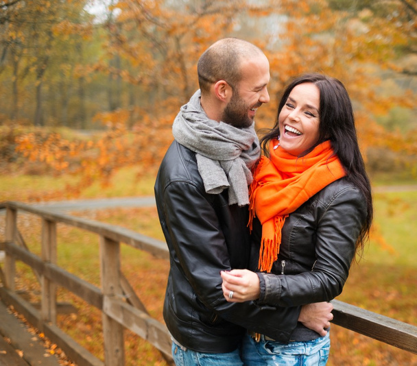 Happy middle-aged couple outdoors on beautiful autumn day - 写真・画像