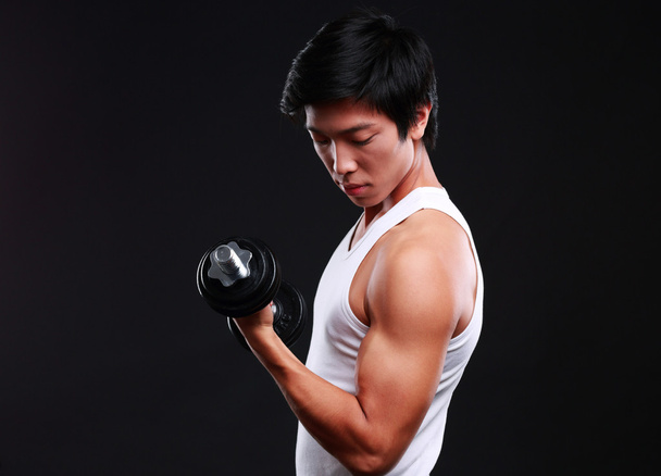 Handsome fit asian man isolated on black background - Photo, Image