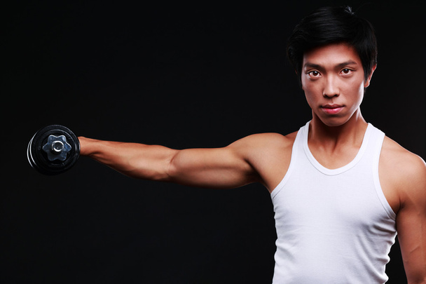 Handsome fit asian man isolated on black background - Foto, imagen