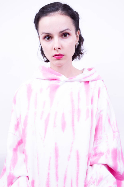 girl in a pink hoodie with pink lipstick on her lips - Fotoğraf, Görsel