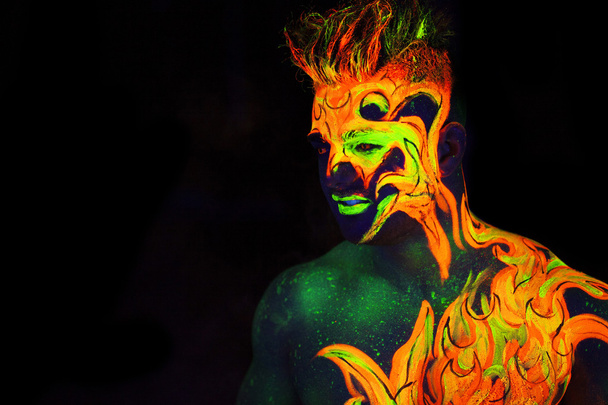 Body art glowing in ultraviolet light  - Фото, зображення