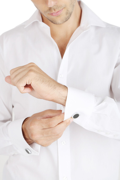 Man in white shirt doing collar button up closeup - Foto, immagini
