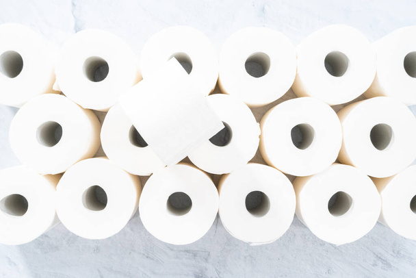 Flat lay. New white toilet paper rolls on a gray background. - 写真・画像