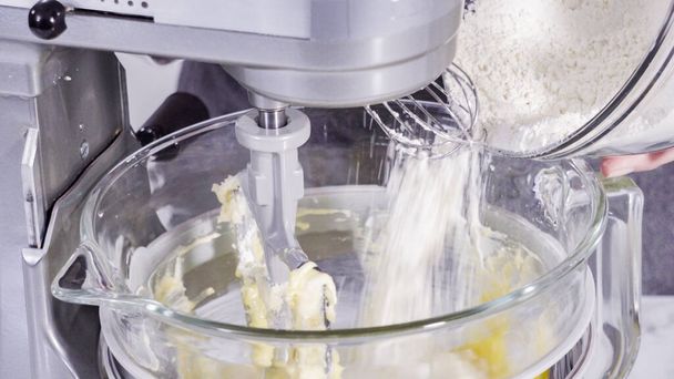 Step by step. Mixing ingredients into the batter for lemon pound cake. - Foto, afbeelding
