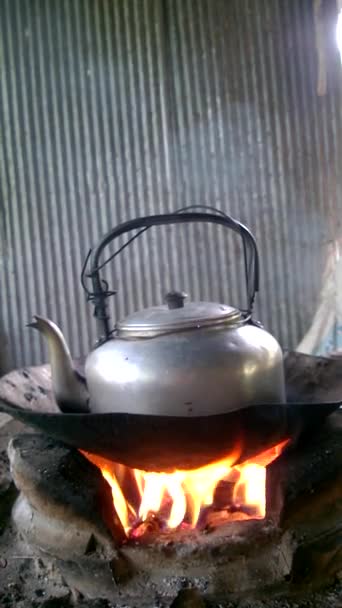 Thai-style charcoal stove with kettle placed on top located in the kitchen. An old hot Kettle on A stove used for a long time in house. Use hot water to make drinks such as coffee, by setting camera - Footage, Video
