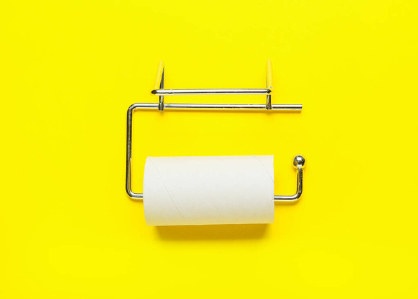 Holder with empty toilet paper tube on yellow background - Photo, Image