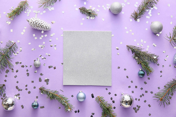 Композиція з порожньою карткою, ялинковими гілками та різдвяними прикрасами на бузковому фоні
 - Фото, зображення