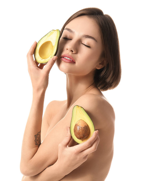 Naked young woman with avocado on white background. Vegan Day - Photo, Image