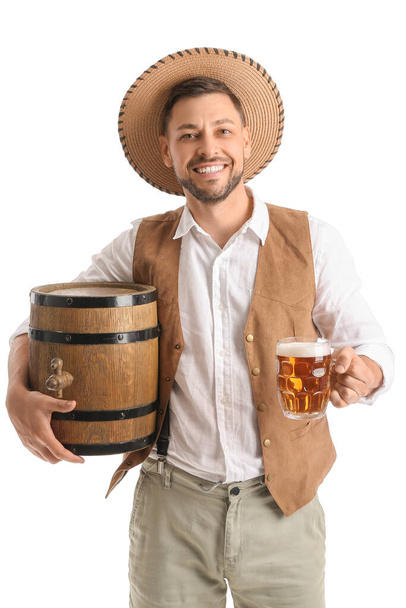 Young man in traditional German clothes with beer and barrel on white background - 写真・画像