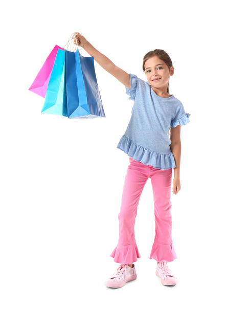 Little girl with Black Friday shopping bags on white background - Фото, изображение