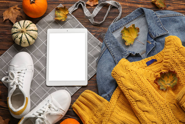 Stylish female accessories, autumn decor and tablet computer on wooden background. Black Friday sale - Photo, Image