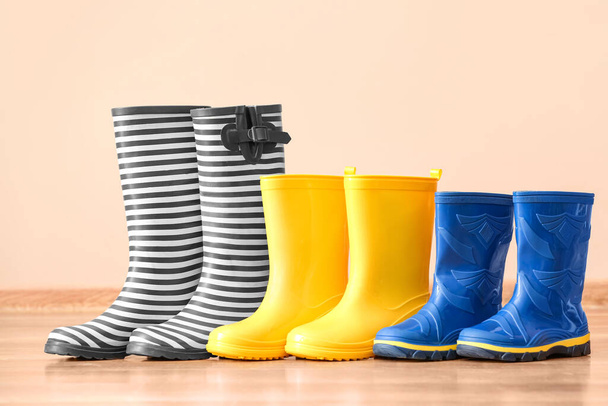 Many different rubber boots near color wall - Photo, Image
