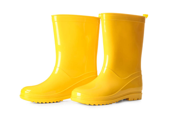 Pair of yellow rubber boots on white background - Фото, изображение
