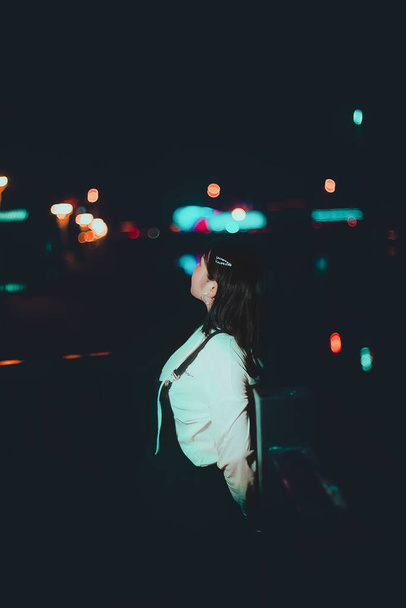 young woman in a night city - Фото, зображення