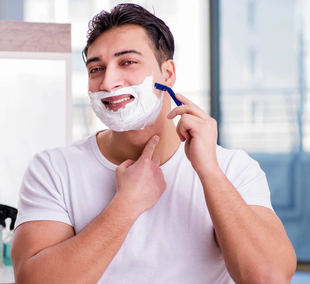 Young handsome man shaving in the morning - Foto, Imagem