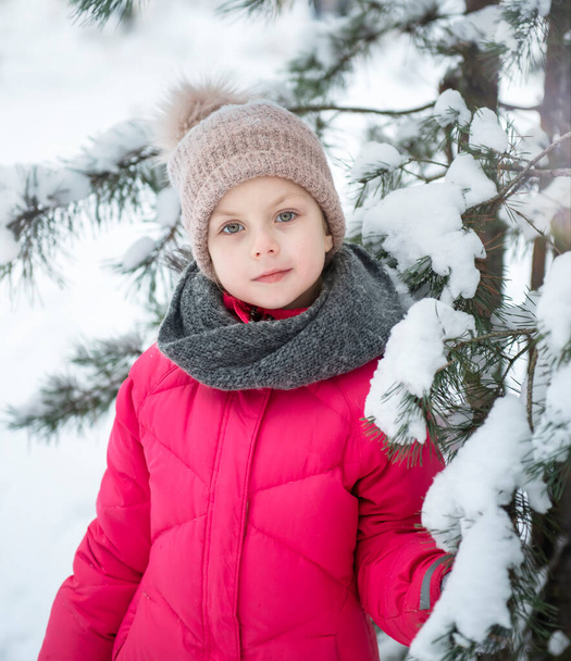 Child in winter. A little girl,  playing in the winter outside. A beautiful winter child portrait. Happy child, winter fun outdoor. - Photo, Image