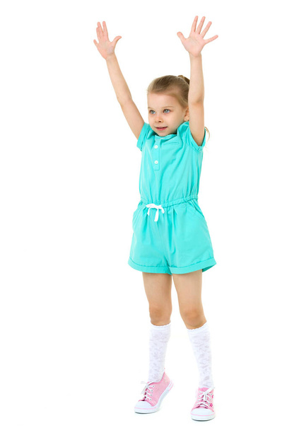 Little girl standing on tiptoes with her hands up - Фото, зображення