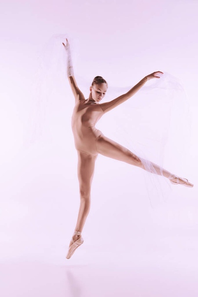 One graceful ballet dancer, ballerina dancing isolated on light studio background. Art, motion, action, flexibility, inspiration concept. - Φωτογραφία, εικόνα