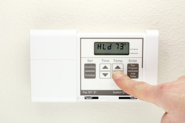 Hand on Thermostat - Photo, Image