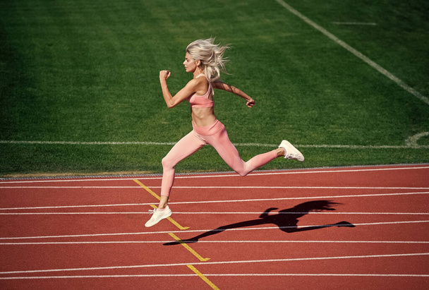 athletic lady compete in sprint. sport healthy lifestyle. fitness training outdoor. runner run fast - Photo, image