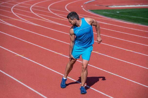 athletic muscular man has trauma after running, health - 写真・画像
