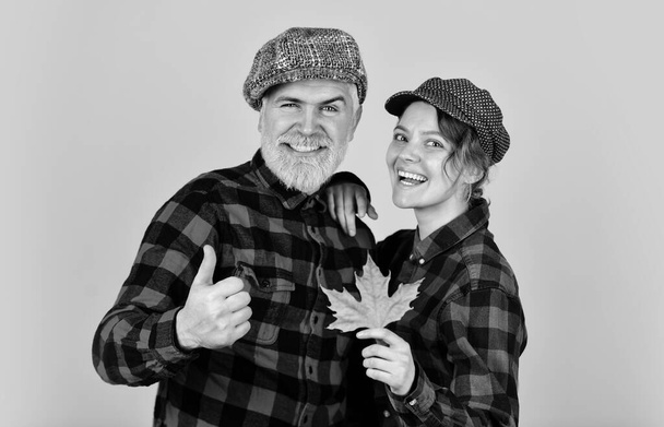 Cheerful couple dating in september. Autumn mood. Family tradition. Couple wear checkered hats and shirts. Vintage style. Romantic feelings. Happy relations. Couple in love stylish outfit. Having fun - Photo, Image