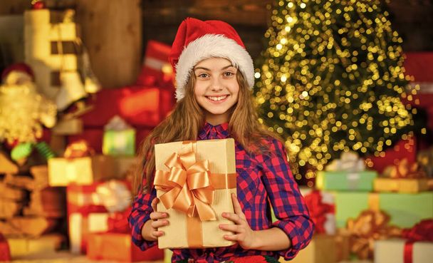 Time to celebrate. delivery christmas gifts. Beautiful decorated room with tree with presents under it. new year scene with tree and gifts. Celebration holiday party. small girl xmas online shopping - Foto, imagen